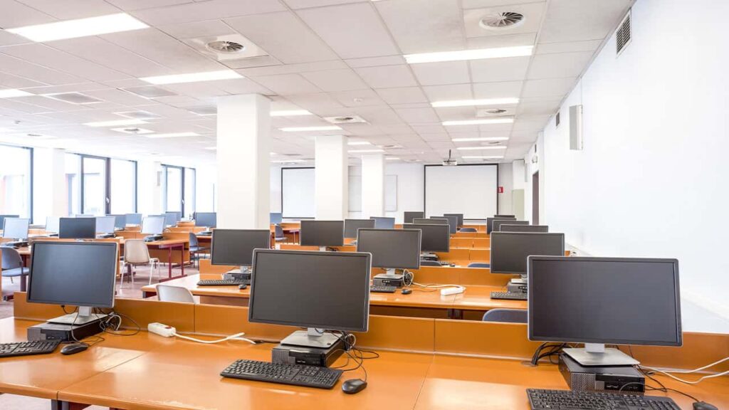 Professional call center environment with agents working at individual workstations, wearing headsets and engaged in customer service operations, showcasing a modern BPO office layout.